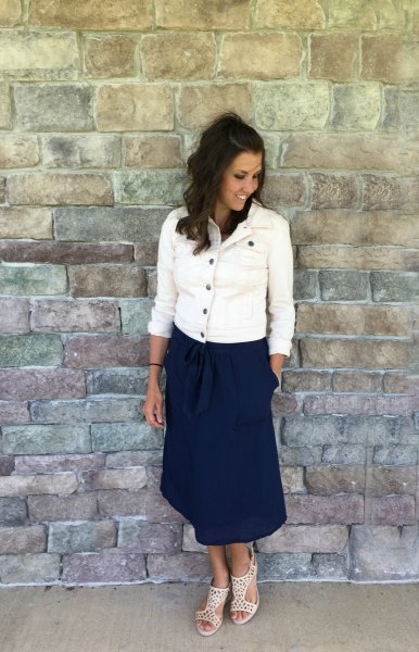 white button down denim jacket and navy blue relaxed fit midi skirt