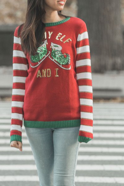 red and white striped knit sweater with a round neckline and light gray skinny jeans