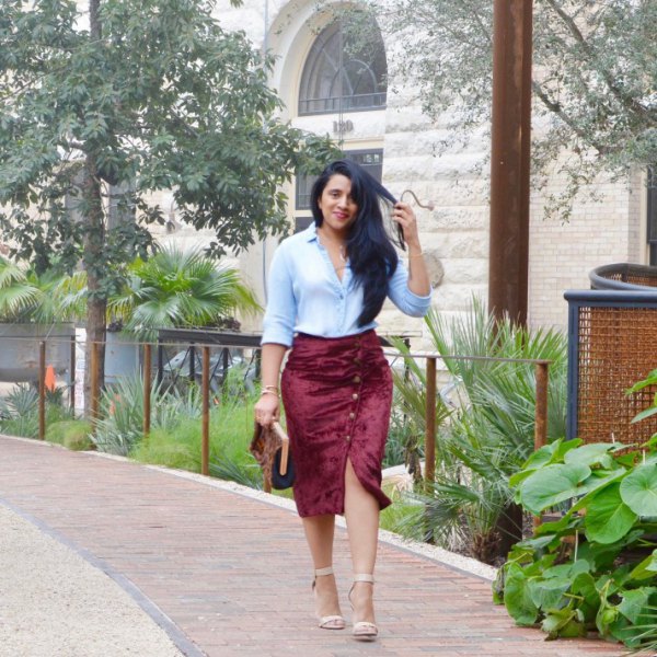 light blue button down shirt and a velvet skirt with a burgundy button down the front