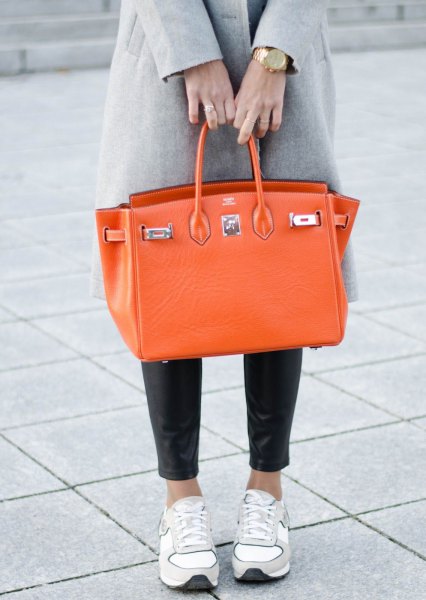 gray wool coat with black leggings and orange leather handbag