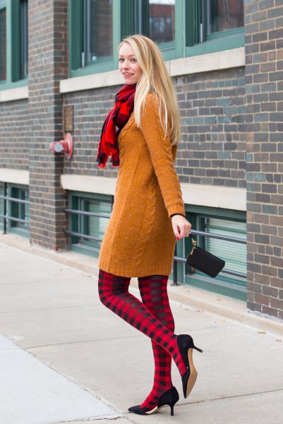 Cable knit sweater dress with red and black plaid leggings