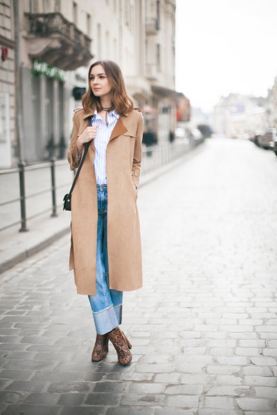 Camel coat with a blue and white vertical striped shirt and cuffed jeans