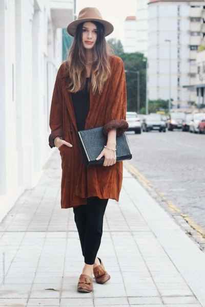 Tan felt hat with a long suede coat and a relaxed fit