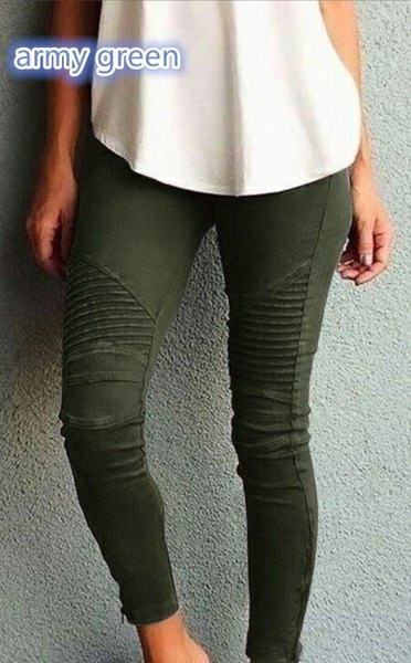 white loose fitting tank top with dark green pleated skinny jeans