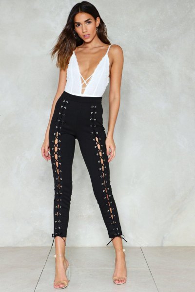 white plunging V-neck top and black skinny lace-up pants