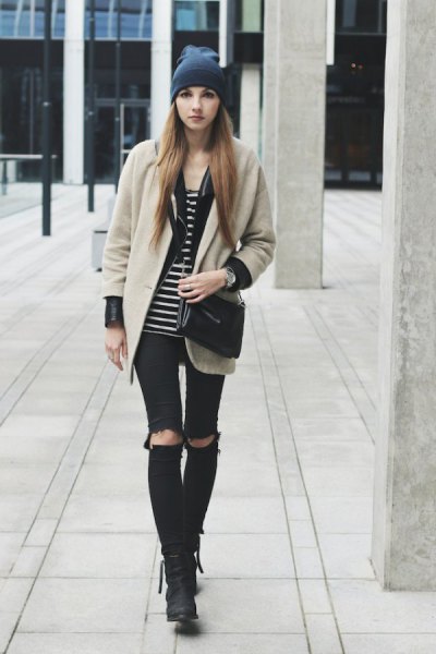 Blush pink wool coat worn with a black and white striped tank top and ripped knee jeans