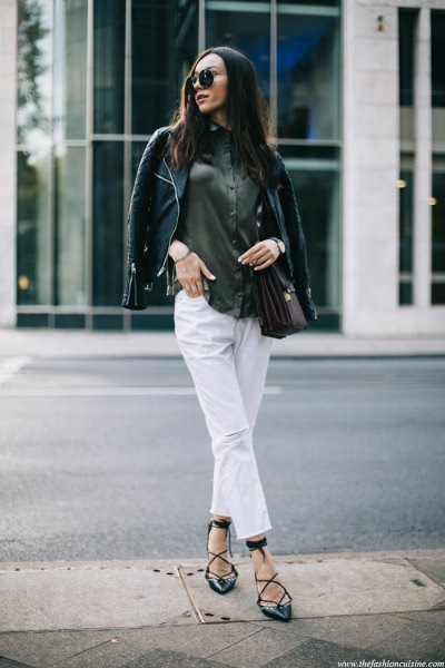 black leather jacket with gray button down shirt and white cropped jeans