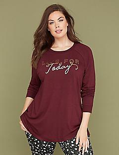burgundy long sleeve graphic tee paired with black and white polka dot pants