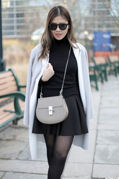 gray wool coat slung over the shoulder black skater skirt