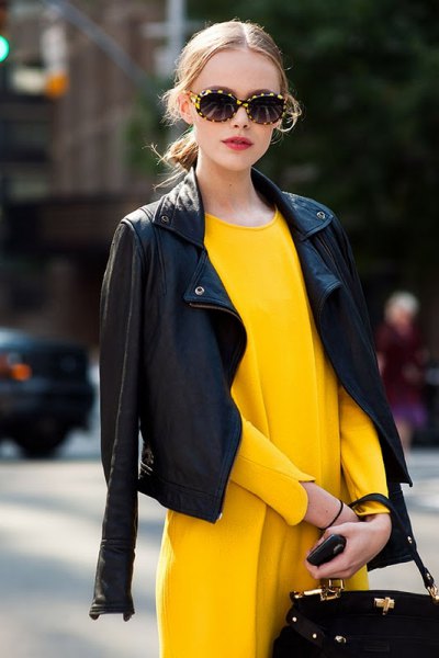 drape black leather jacket over shoulders yellow dress