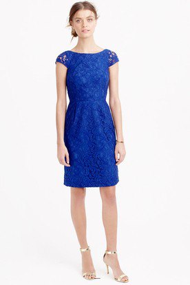 Knee length cap sleeve dress in royal blue with a gathered waist and silver heels
