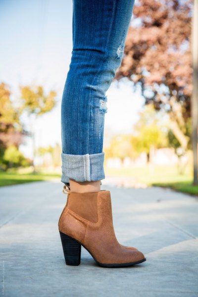 Cuffed blue jeans and brown leather ankle boots