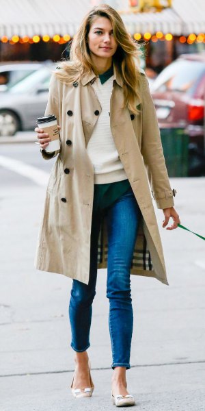 long trench coat with white sweater and blue jeans