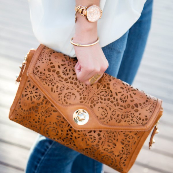 Brown soft leather neckline clutch with white chiffon blouse and blue jeans