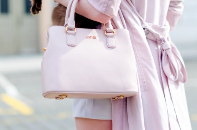 Ivory longline wool coat with white soft leather handbag