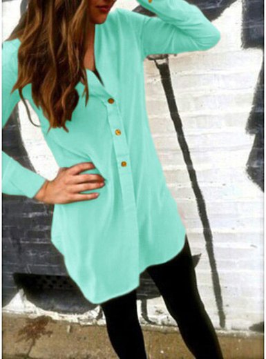 Mint green collarless tunic shirt with buttons and black leggings