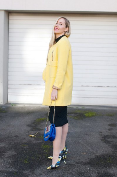 light yellow long wool coat with black knee-length sheath dress