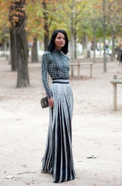 black and white patterned mock-neck blouse with a silver pleated maxi skirt