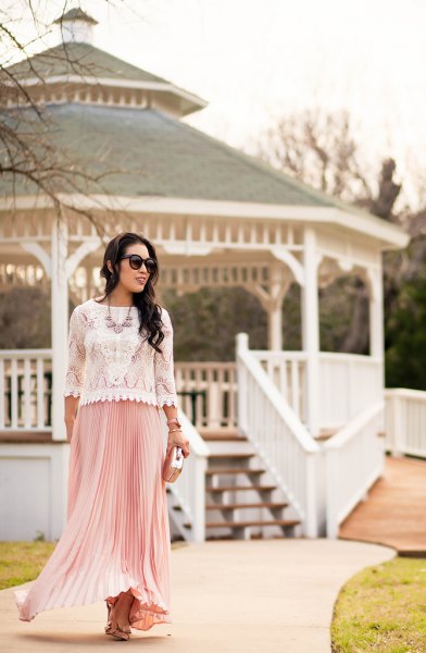 white lace sweater with scalloped hem and pink pleated maxi skirt