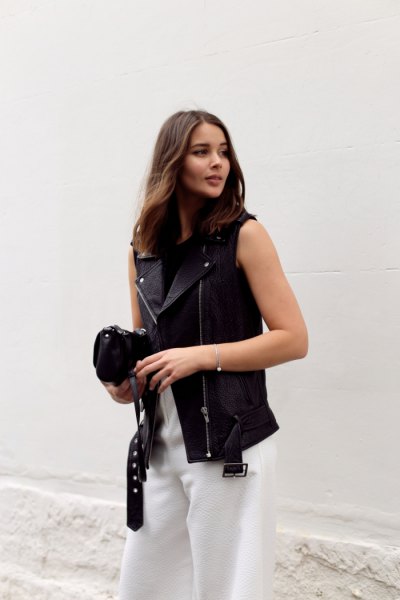 Leather vest, white pants with wide legs
