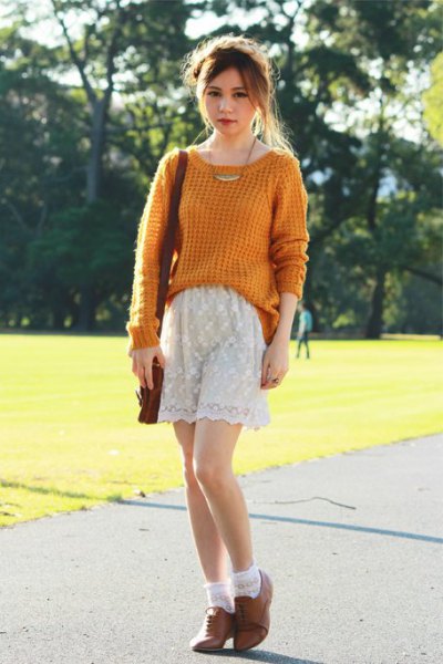 green ribbed knit sweater with white lace shorts