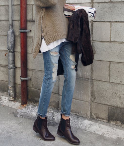 gray side slit sweater with ripped jeans and black leather boots with zippers
