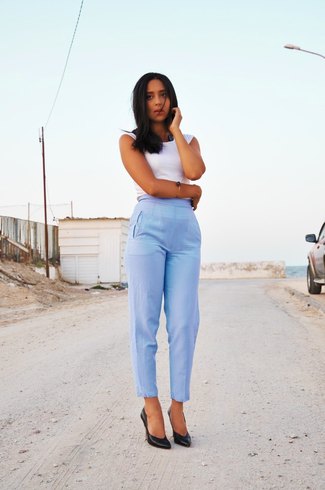 white sleeveless top with light blue high-waisted ankle pants