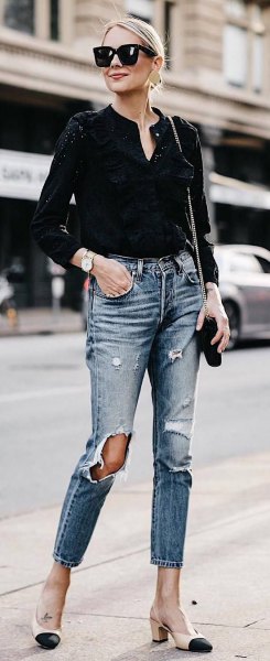 V-neck black mini blouse and ripped slim-fitting ankle jeans