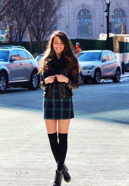 black leather jacket with dark blue checked mini skirt and ankle boots