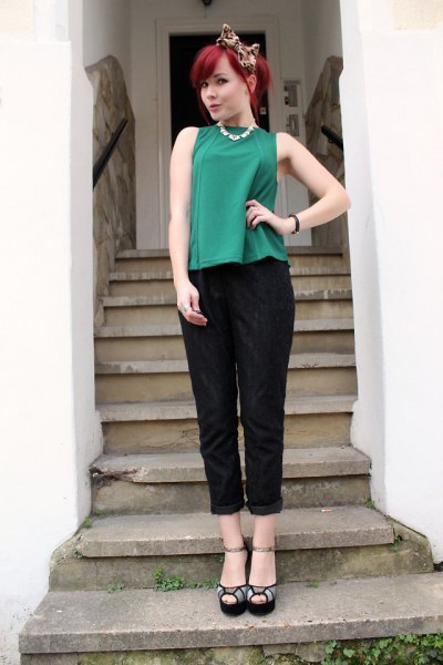 green sleeveless top with black pants with cuffs