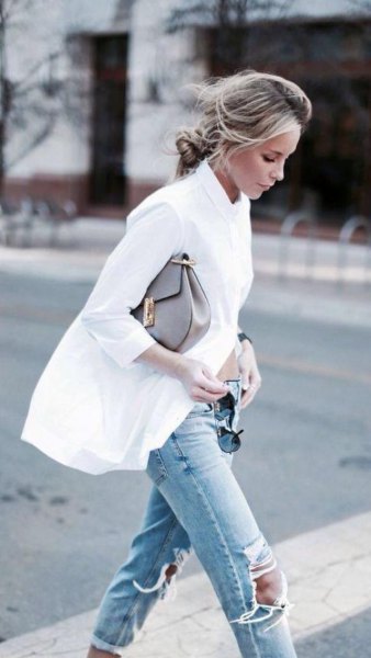 oversized white button down shirt and ripped light blue knee jeans