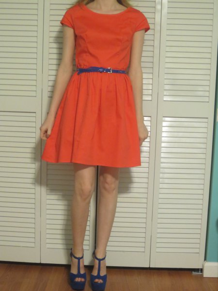 orange mini cat dress with cap sleeves and blue, narrow leather belt