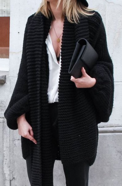 black chunky knit cardigan with white blouse and leather handbag