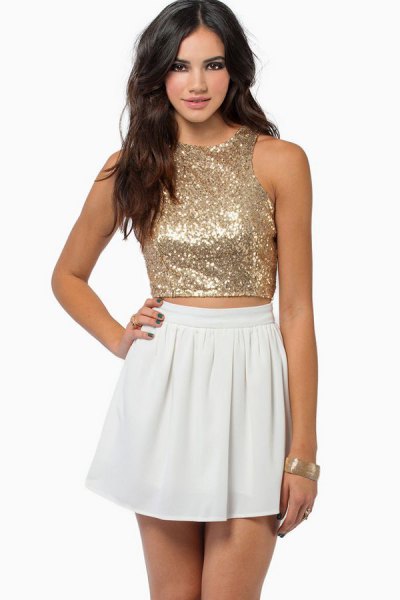 Rose gold sequin cropped vest top with white mini skirt
