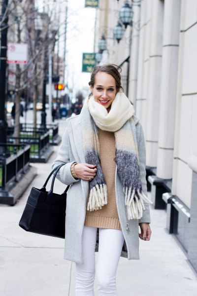 Blush pink sweater worn with light gray wool coat and white jeans