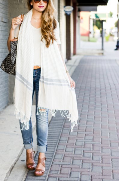 white fringed long scarf, white cropped t-shirt and cuffed blue jeans