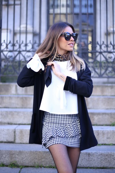 Mini skirt with white blouse and black wool coat