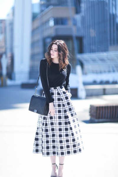 black crew neck sweater with high waisted plaid midi skirt