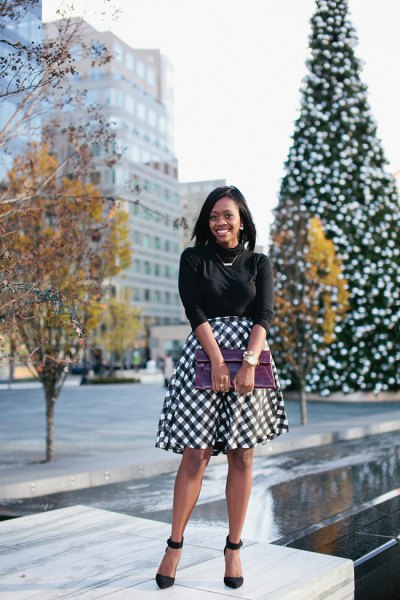black knit sweater with half sleeves and plaid midi skirt