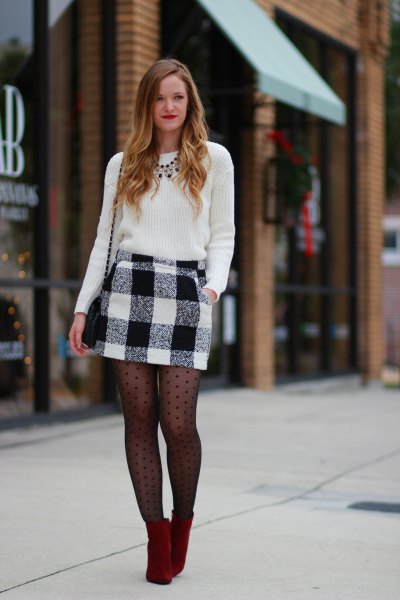 black knit sweater and black patterned stockings