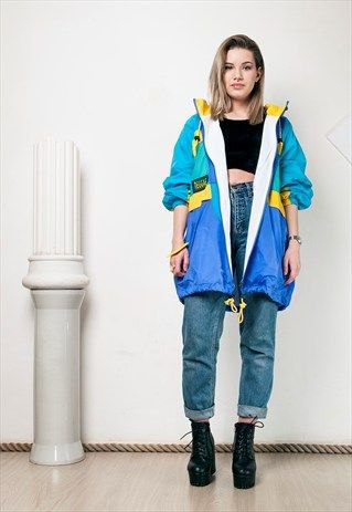 blue, pink and yellow windbreaker with black crop top and high rise jeans
