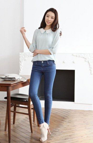 light pink blouse with a round collar and blue jeans