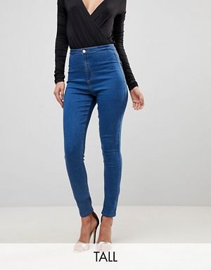 black low rise long sleeve V-neck top and blue high rise jeans