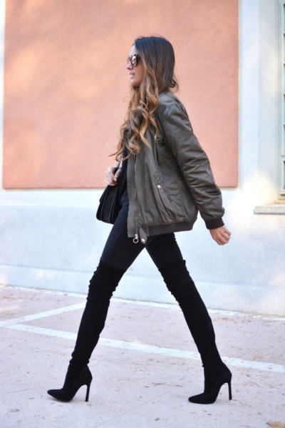 gray bomber jacket with black jeans and mid-calf boots