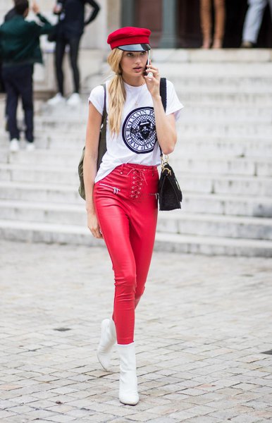 white cool graphic tee with a red painter hat and matching leather leggings