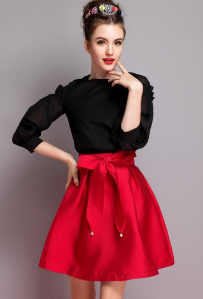 black knit sweater, red knotted flared skirt