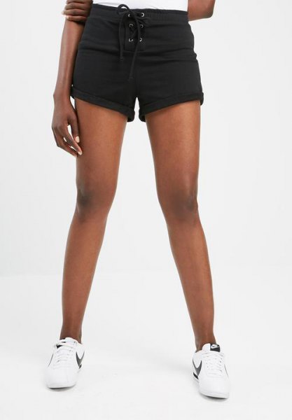 black mini sweat shorts with cuffs, white t-shirt and sneakers
