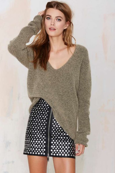 gray oversized ribbed V-neck sweater with polka dot skirt