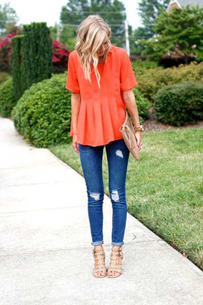 orange peplum blouse with ripped skinny jeans