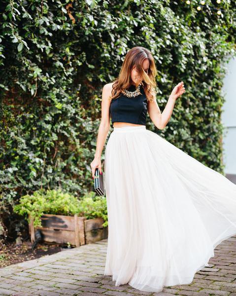 black cropped sleeveless top with white pleated high waisted maxi skirt